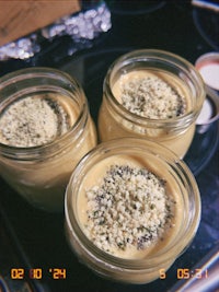 three jars of food on top of a stove