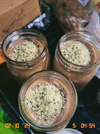 three jars of chocolate pudding on a tray