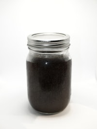 a jar of coffee in a white background